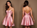 Blush pink satin mini dress with a lace bustier top, thin straps, and a flared skirt.