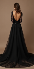 An elegant black wedding gown featuring an open-back lace design with a flowing chiffon A-line skirt and a subtle train – a vision of gothic romance.
فستان زفاف أسود أنيق يتميز بظهر مفتوح مزين بالدانتيل، مع تنورة شيفون منسدلة وقصة A-Line مذهلة – يجسد الرومانسية القوطية.
Un vestido de novia negro elegante con diseño de espalda abierta de encaje, falda fluida de chifón en A-Line y una sutil cola – una visión de romance gótico.
